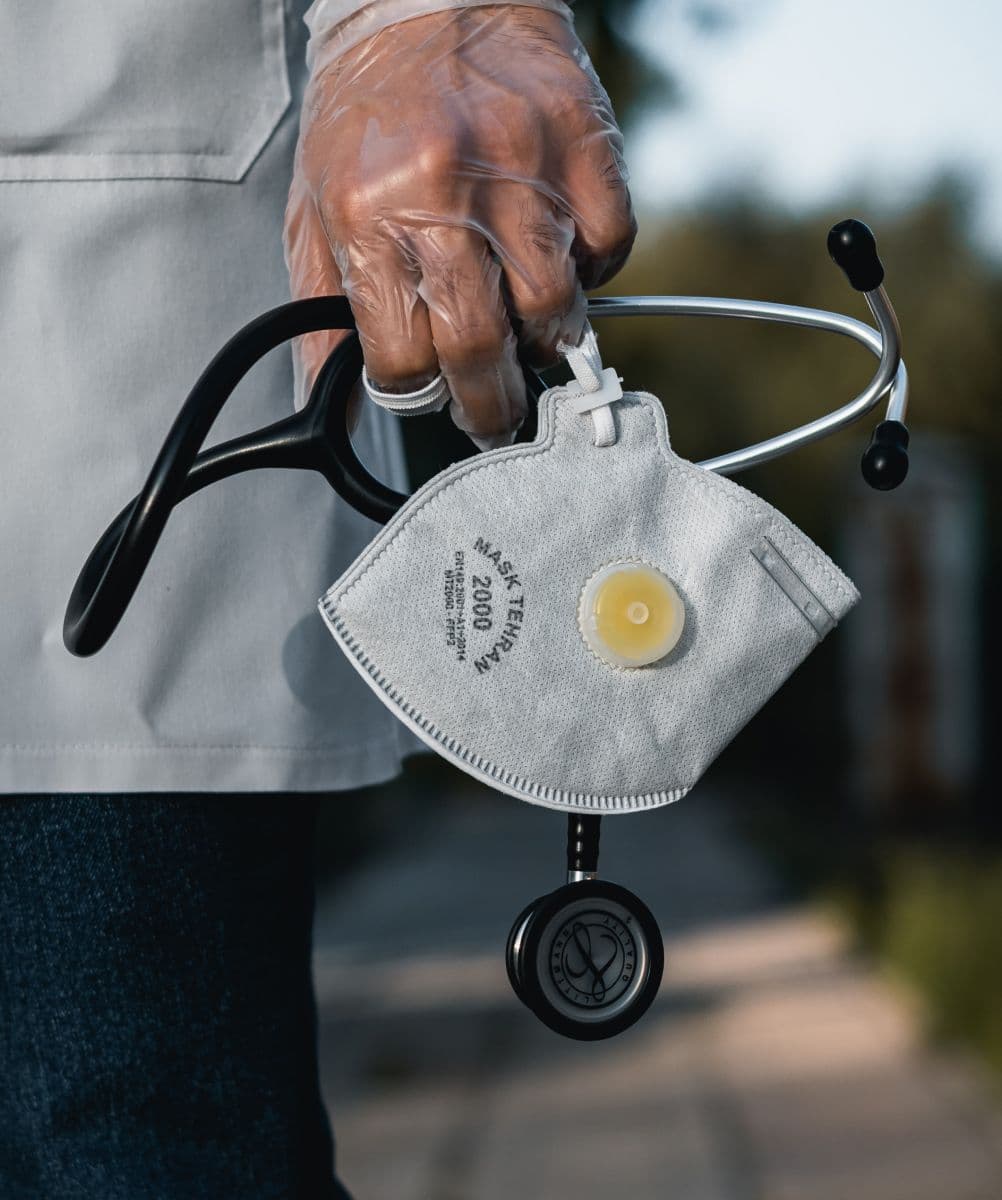 Doctor holding a mask and a stethoscope